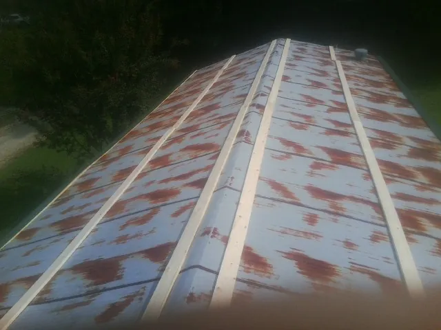 Rusted metal roof panels with new wood purlins before replacement — Storm Damage Roof Repair in Bonner by Roofing Brothers